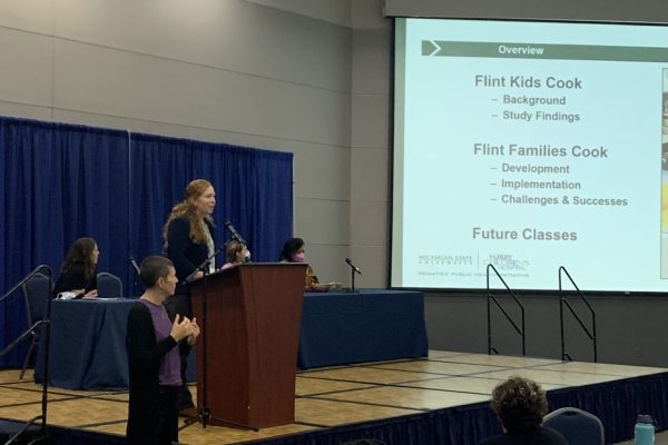 Sarah Egan presenting about Flint Families Cook at the Healthy Flint Research Coordinating Center Research Symposium in 2022.